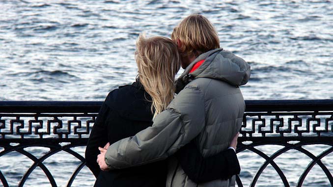 Couple Hugging At The Pier