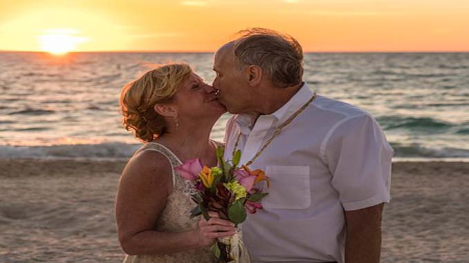 Couple Kissing On The Beach