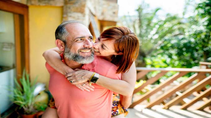 Mature Man Giving A Piggyback To A Younger Woman