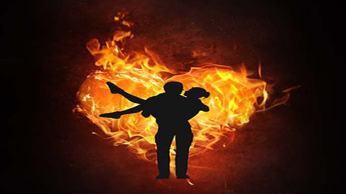 Man Carrying A Woman Thru A Heart Of Fire