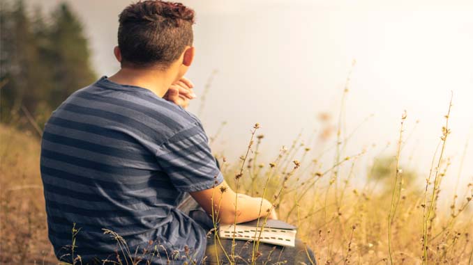 Man Contemplating Life In A Field