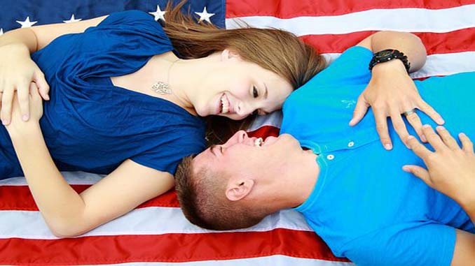 Man And Woman Laying On A Flag