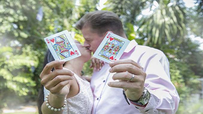 Married Couple Holding Playing Cards