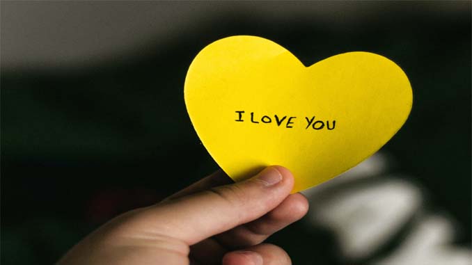 Man Holding A Paper Heart - "I Love You"