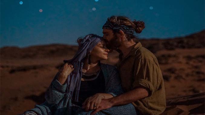 Man And Woman Embracing On The Beach