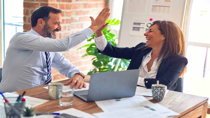 Business Man And Woman Hi Fiving