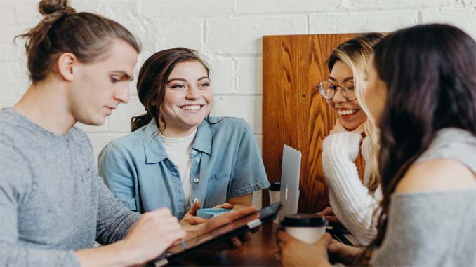Four People Around A Table Talking