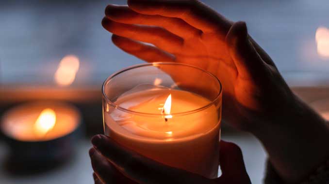 Hand Above A Lit Candle