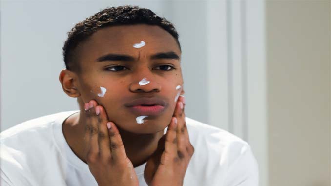 Man Applying Moisturizer To His Face