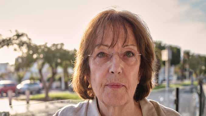 Woman Standing On A Pier