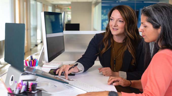 Two Women Working On A Computer