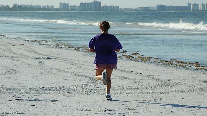 Woman Jogging On The Beach