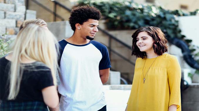 Four People Chatting On The Street