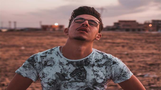 Man With Closed Eyes In A Field