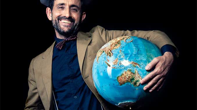 A Man Holding A Globe