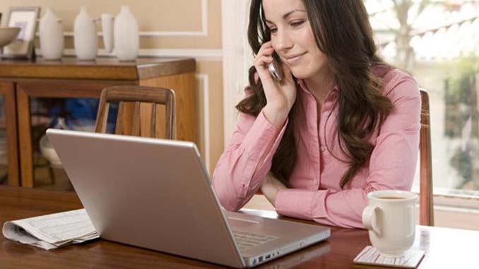 Woman On The Phone With Her Laptop