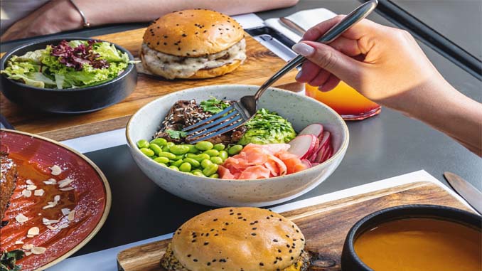 People Enjoying Burgers, Salad And Soup