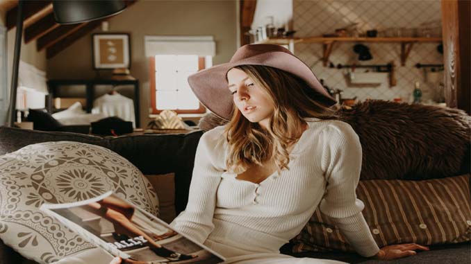 Woman On Couch Reading Magazine