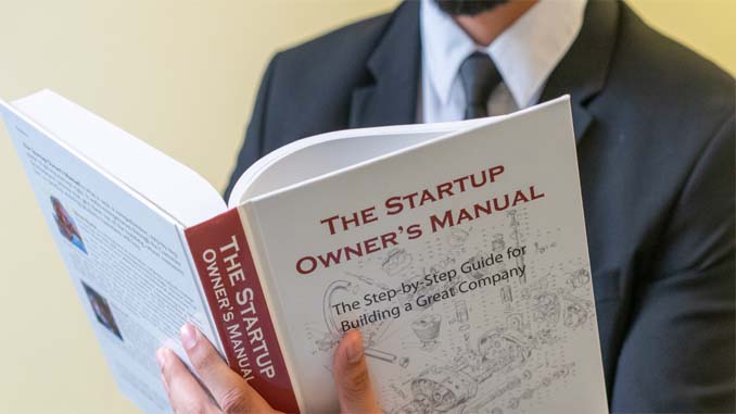 Man Reading From A Manual