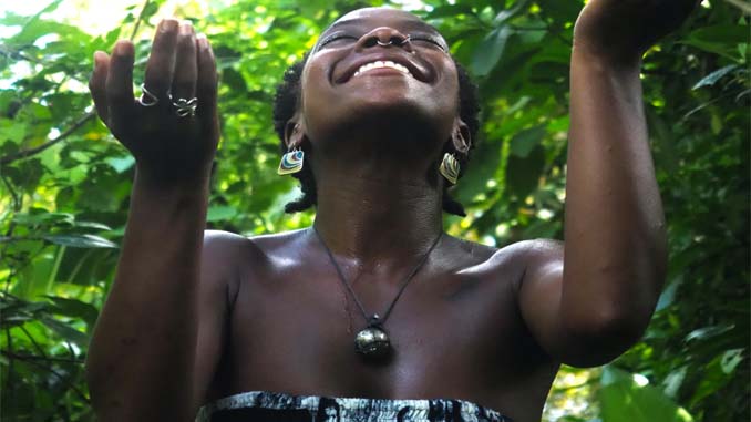 Smiling Woman With Her Hands To Heaven