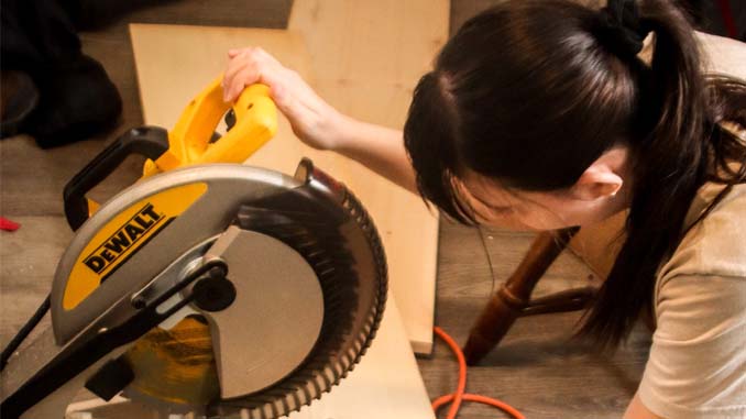 Woman Preparing To Cut Wood
