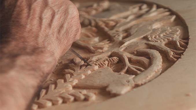 Man Creating Design On Wood