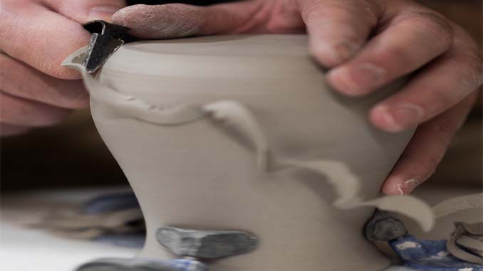 Man Sculpting A Vase