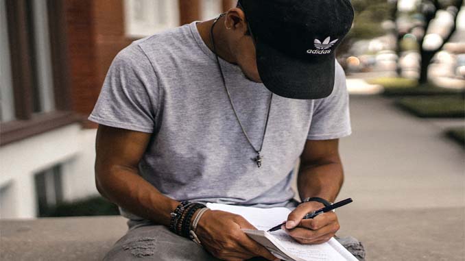 Man Writing In His Journal