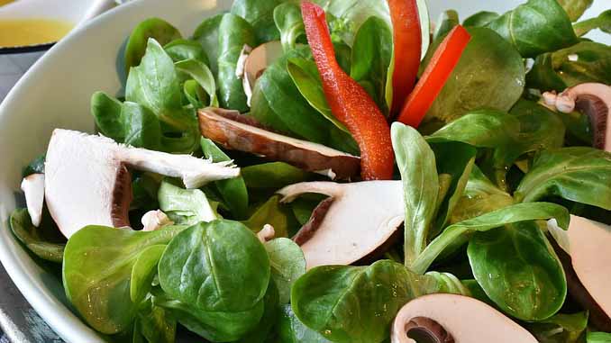 A Salad With Spinach, Bell Peppers And Heart Shaped Mushrooms