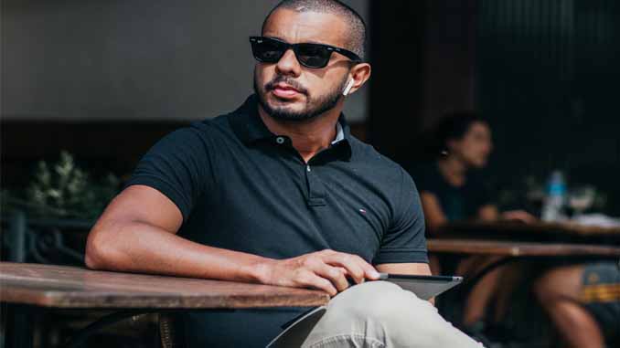 Man Wearing Sunglasses At An Outdoor Café