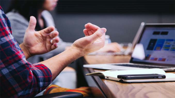People Sitting Around A Table Talking