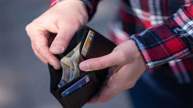 Man Looking In His Wallet