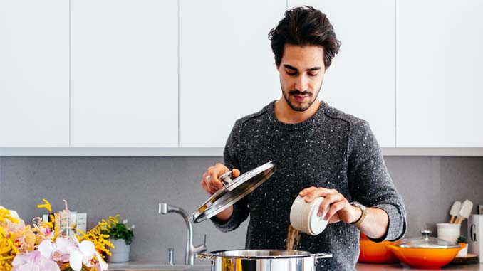 Man At Stove Preparing A Meal
