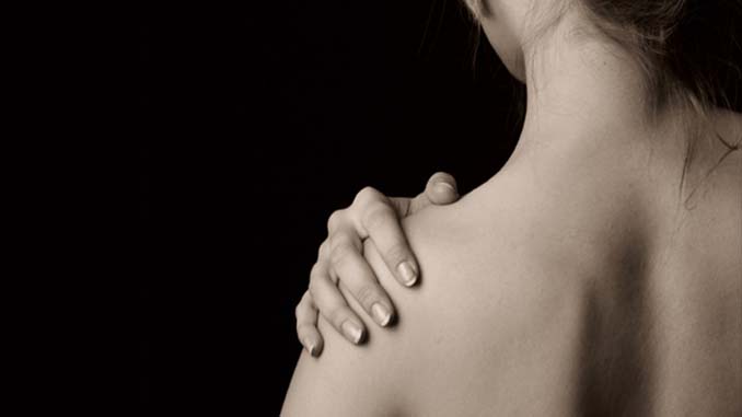 Woman Holding Her Shoulder