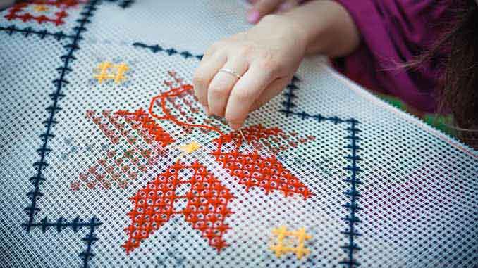 Woman Cross Stitching