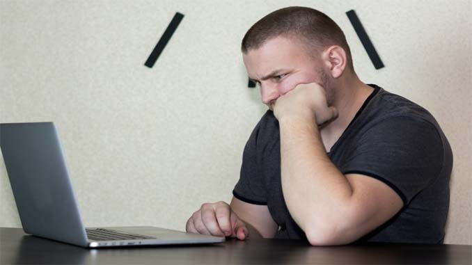 Frustrated Man At Laptop