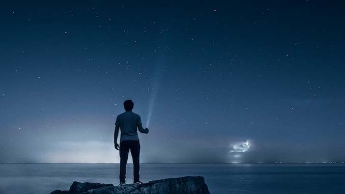 Man At Night With A Flashlight