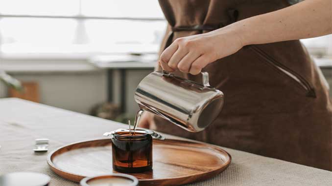 Wax Being Poured Into A Jar
