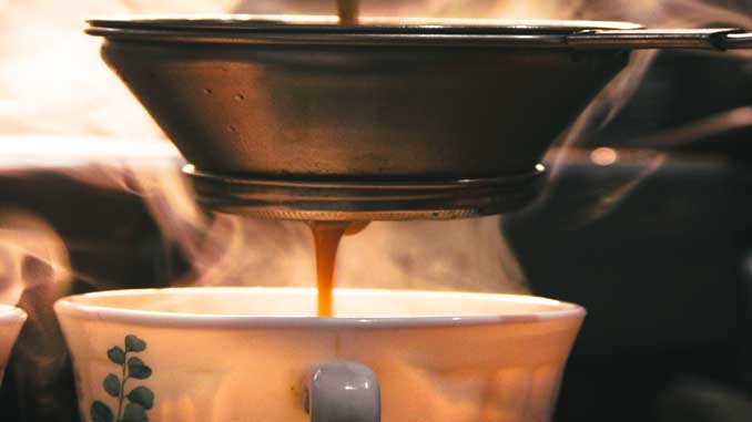 Wax Being Poured Into A Tea Cup