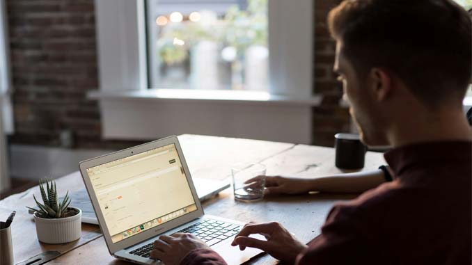 Man And Woman In Front Of A Laptop