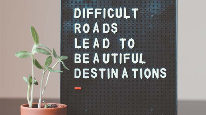 Board Reading "Difficult Roads Lead To Beautiful Destinations"