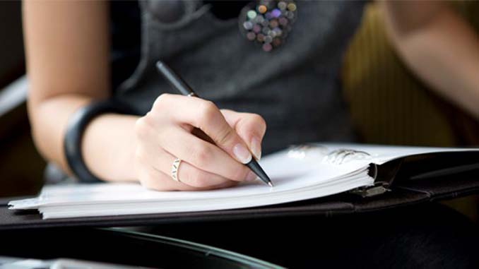 Woman Writing In Her Journal