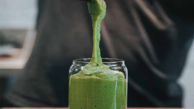 Green Smoothie Being Poured Into A Glass