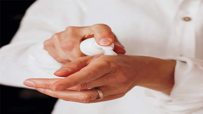 Woman Applying Lotion To Her Hands