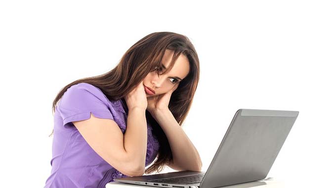 Perplexed Woman In Front Of A Laptop