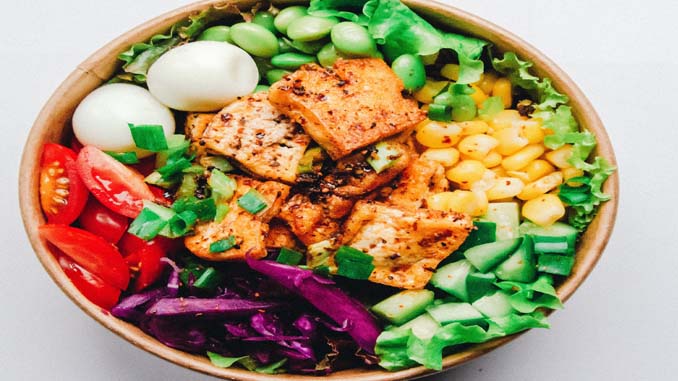 A Salad With Meat, Eggs, And A Variety Of Veggies