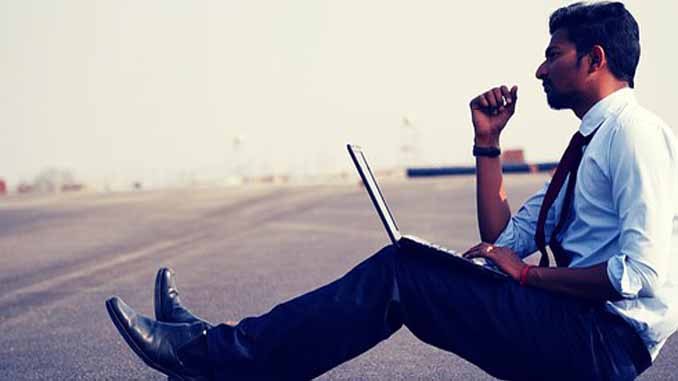 Man On The Side Of A Highway With Laptop