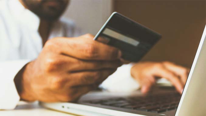 Man With Credit Card Making Purchase Online