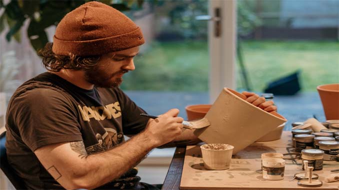 Man Painting A Pot