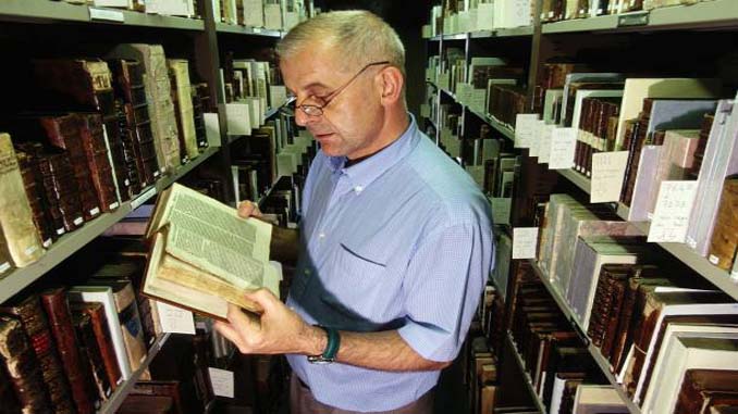 Man Reading An Old Book